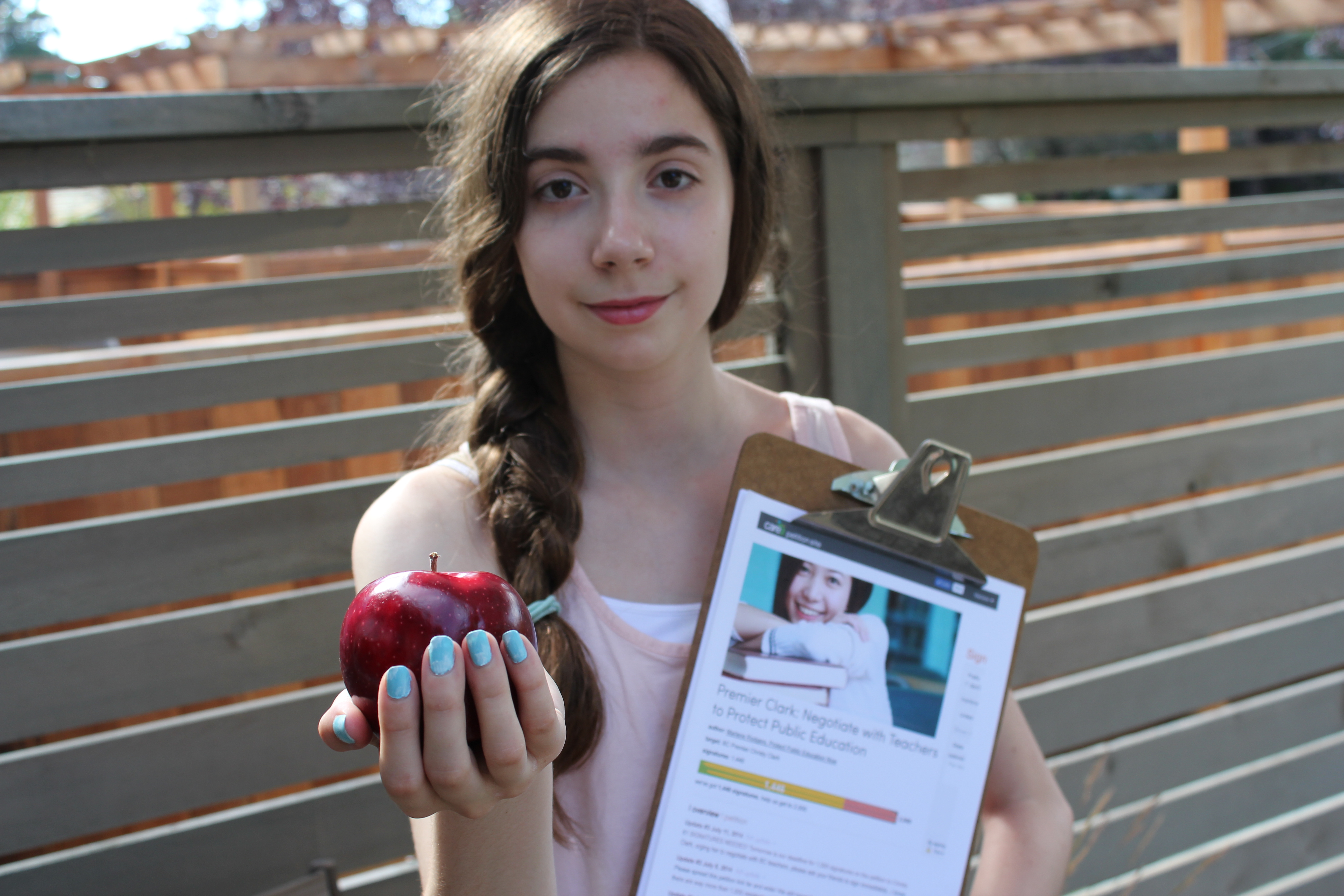 Julia Pante with apple and petition